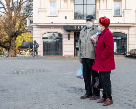 UZHHOROD, UKRAINE - APRIL 10, 2020: Quarantine in the city of Uzhhorod due to the COVID-19 virus. People in protective masks in the streets of the cityのeditorial素材