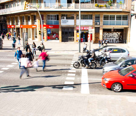 BARCELONA, SPAIN - FEBRUARY 23, 2019: Busy city street people on zebra crossing. Intentional motion...