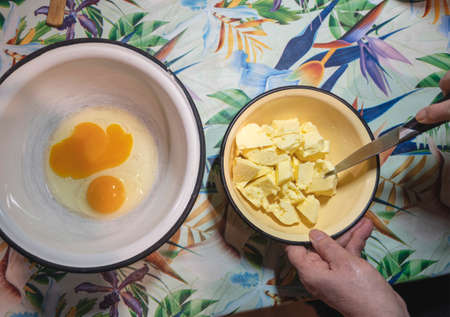 Senior woman preparing ingredients for homemade cake at home