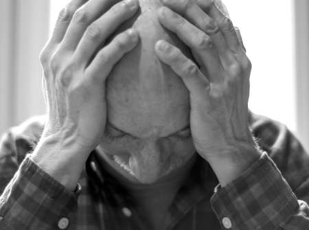 Healthcare, pain, stress and age concept. Sick old man. Senior man suffering from headach at home