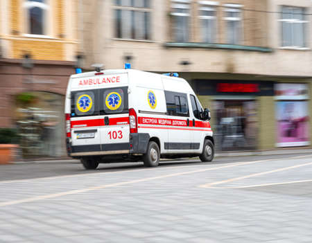 Uzhhorod, Ukraine - November 4, 2020: An ambulance responding to emergency call driving fast on street in motion blur in Uzhhorod, Ukraine. Defocused image. Healthcare conceptのeditorial素材