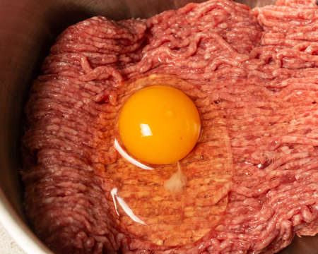 Food concept. Minced meat with egg prepared for cooking