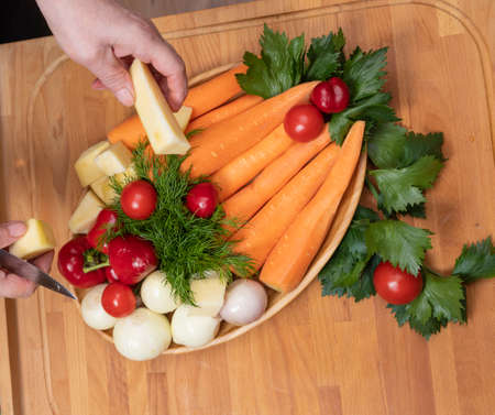 Woman preparing vegetable for salad in the kitchen. Healthy Food.  Dieting Concept. Healthy...