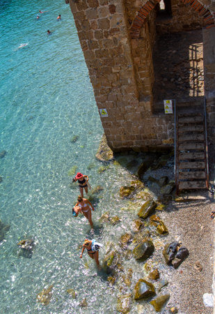 Alanya, Turkey - August 31, 2021: Tourists swimming in the Mediterranean Sea at the city walls of Alanya in Turkeyのeditorial素材