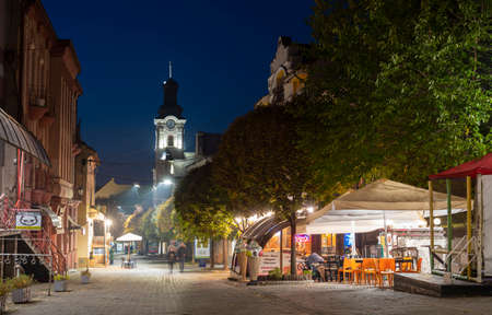 Uzhhorod, Ukraine - October 31, 2021: Voloshyna street in the evening in Uzhhorod, Ukraine. Roman Catholic cathedrla on the background. The center of the Uzhhorod cityのeditorial素材