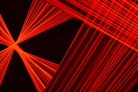 Abstract red lines drawn by light on a black background. Laser lines