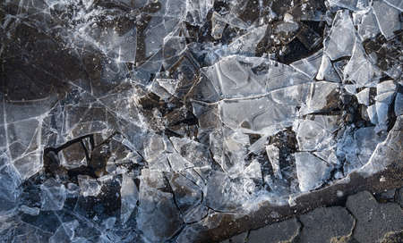 Cracked ice texture. Top view. Broken ice on the ground