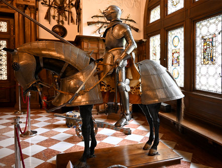 Sinaia, Romania - May 27, 2023: Knight and horse armour in Grand Armory Hall of Peles Castle in Romaniaのeditorial素材
