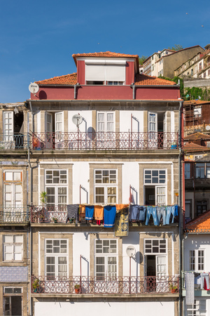 PORTO, PORTUGAL, APRIL 27, 2014: View of facades, alleyway and traditional houses in Ribeira old and historic town and alongside Douro River, Porto, Portugalのeditorial素材