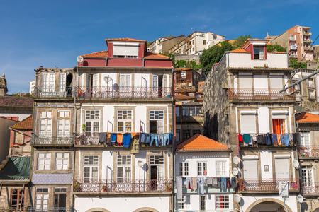 PORTO, PORTUGAL, APRIL 27, 2014: View of facades, alleyway and traditional houses in Ribeira old and historic town and alongside Douro River, Porto, Portugalのeditorial素材