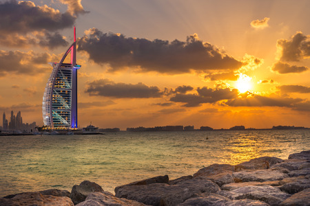 Dubai, United Arab Emirates - Dec 2, 2014 : View of the illuminated Burj Al Arab, a luxury 7 stars hotel, at the sunset,  from the Jumeirah beach opposite side, Dubai.のeditorial素材
