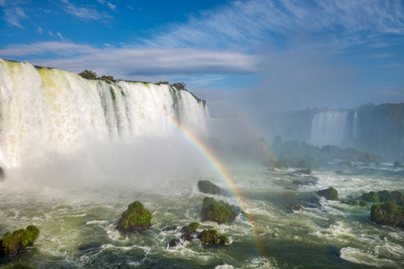 Close view of one of the Cataratas water falls under blue sky and a lot of water mist in the air at the Foz do Iguassu park, Brazil.の写真素材