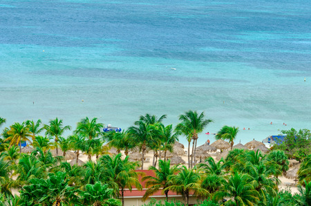 Aruba, Caribbean - September 25, 2012: Tourists enjoying the blue caribbean sea in Aruba Islandのeditorial素材