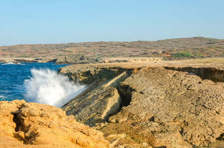 Panorama view of the turquoise natural bridge beach at the Caribbean sea in Aruba.の写真素材