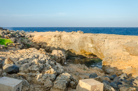 Panorama view of the turquoise natural bridge beach at the Caribbean sea in Aruba.の写真素材