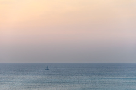 Sailboats on sea navigating under the sunset. The image was taken from Palm Beach in Aruba, in the Caribbean Sea.の写真素材