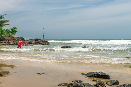 Itacare, Brazil - December 7, 2016: Fisherman at the amazing nature at the Itacarezinho beachのeditorial素材