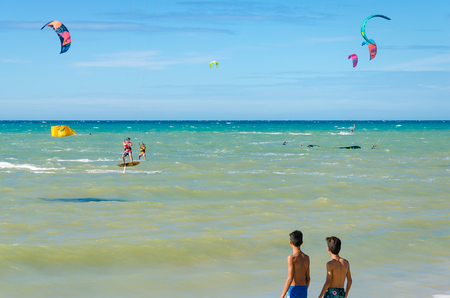 Cumbuco, Brazil, jul 9, 2017: Kids observing kite surfer equipment on the sea in Cumbucoのeditorial素材