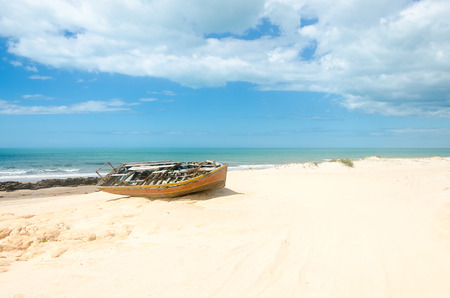 Canoa Quebrada, Brazil, jul 12, 2017: Front view of a broken canoe over the white sandy beachのeditorial素材