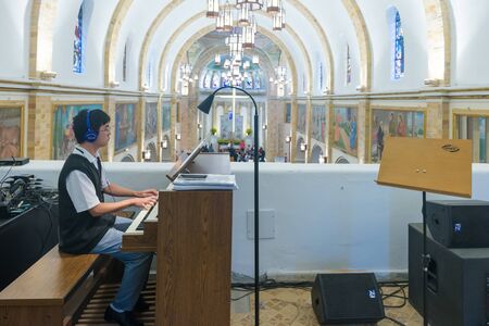 Sao Paulo, Brazil, mai 26, 2018: Young boy playing keyboard at the Our Lady Appeared church in Sao Pauloのeditorial素材
