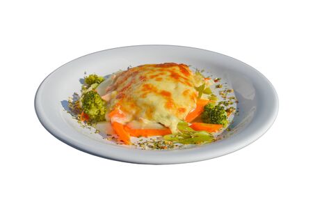 Tasty salmon lasagna with vegetables as a side. White isolated backgroundの写真素材