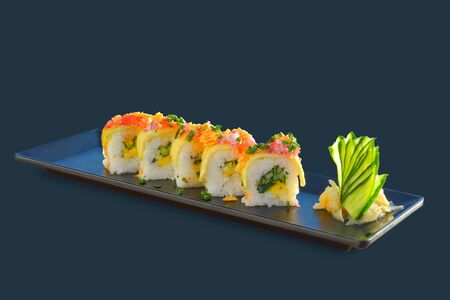 Vegetarian sushi roll with mango, cucumber, parsley. Japanese food on black backgroundの写真素材