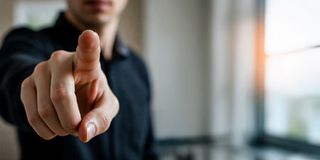 Man Pointing Directly Toward Camera, Emphasizing Urgency, Command, Attention, and Direct Communication Through a Clear and Assertive Gestureの素材