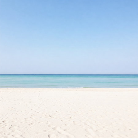 Tropical Beach Paradise: Serene Coastal Scene with Golden Sands, Azure Waters, and Distant Island Under a Clear Blue Sky.の素材