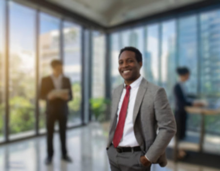Businessmen blur in the workplace or work space of table in office room with computer or shallow depth of focus of abstract background.の素材