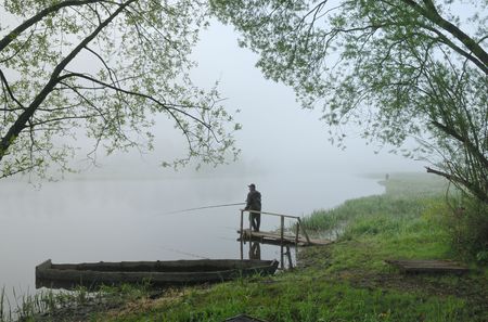 Fishermen on the river early in the morning, before sunriseの写真素材