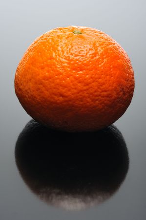 Mandarin on a black background and its reflectionの写真素材