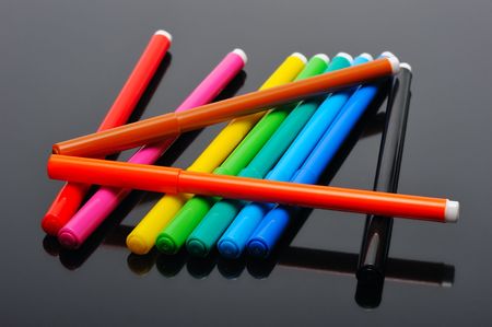 A set of colored felt pens on a black backgroundの写真素材