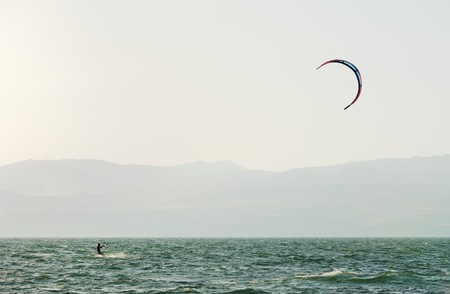 Sky-surfing in the rays of the setting sun on lake Kinneretの写真素材