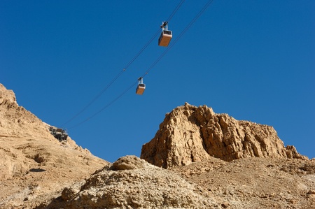 Cableway cabins descends from the fortress Masada.の写真素材