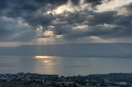 Lake Kinneret in the morning, sun rays are shining through the clouds の写真素材