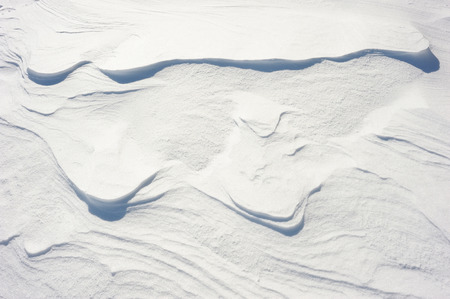 Coarse texture of the snow, accented by a sliding sun lightの写真素材