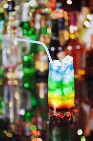 Cocktail rainbow on the bar on the blur background.の写真素材