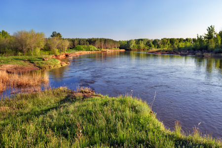 Spring landscape with river and blue skyの写真素材