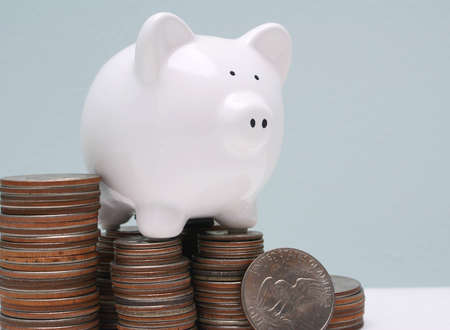 Piggy bank on pile of silver dollars