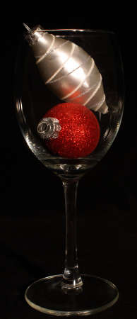 Red and silver christmas ornaments in wine glassの写真素材