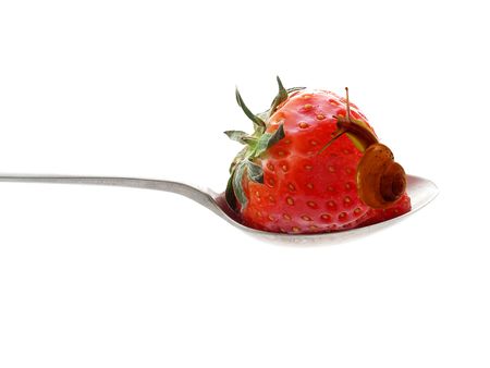 Strawberry on a silver spoonの写真素材