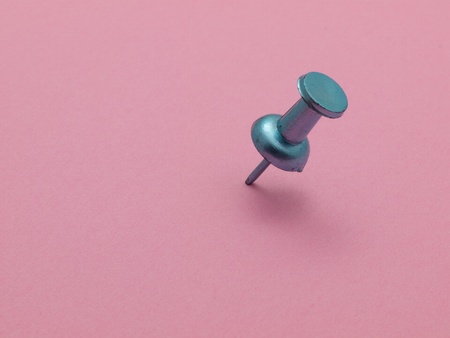 push pin in pink paperの写真素材