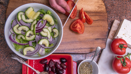Preparing a fresh, healthy, organic Greek saladの写真素材