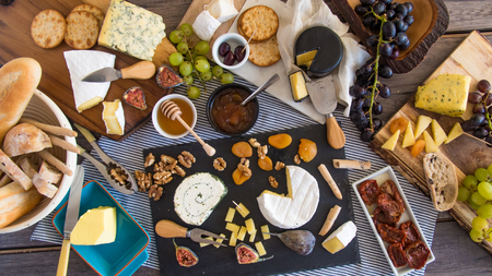Top down view of an assortment of French and British cheese with figs and walnutsの写真素材