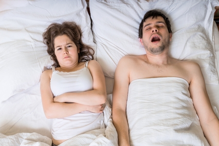 Angry woman cant sleep and listening her husband snoring.の写真素材