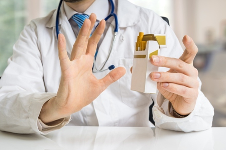 Doctor is warning against smoking cigarettes and giving advice to quit smoking.の写真素材