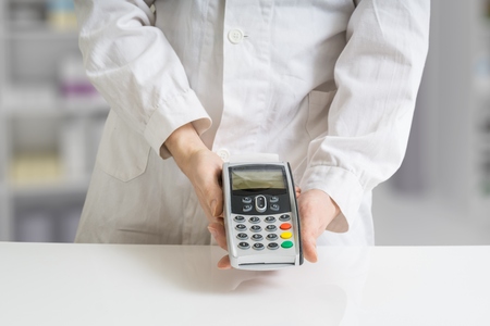Paying with payment terminal in pharmacy.の写真素材