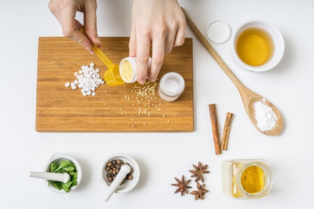 View from top on hands preparing homemade cosmetics from ingredients.の写真素材