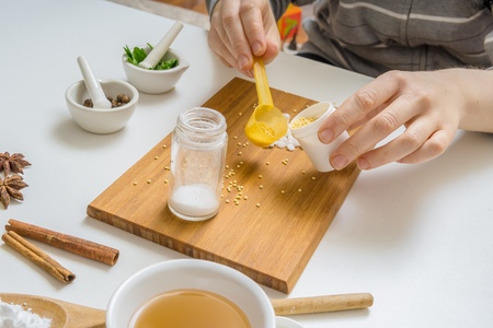 Woman is making homemade cosmetics or makeup from ingredients.の写真素材