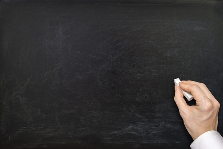 Hand of teacher and empty blackboard.の写真素材